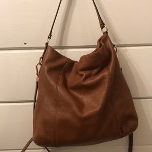 Brown leather Coach hobo style crossbody handbag.